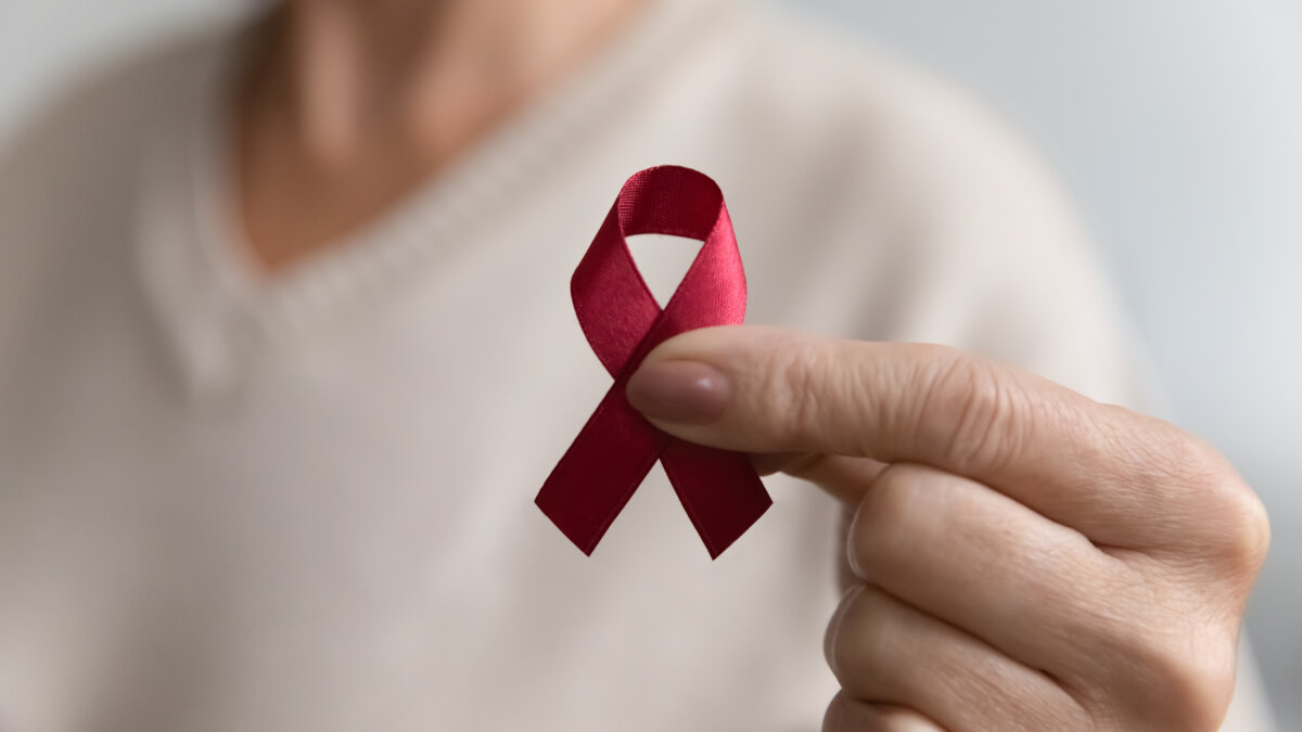 Hand holding HIV Awareness Ribbon